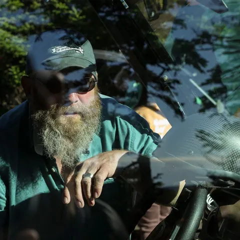 Bearded driver at the wheel of an off-road vehicle