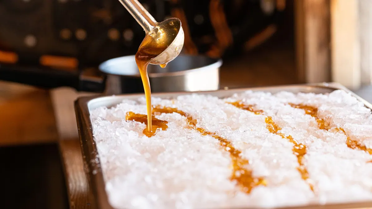 Hot maple syrup poured onto snow to make maple taffy