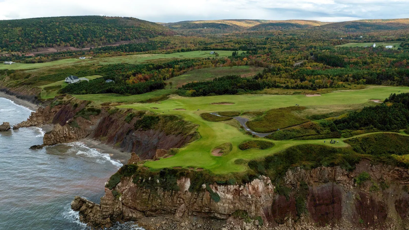 Golf green at Highlands Links between forest and ocean