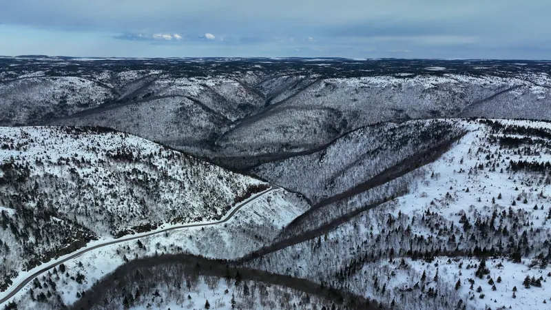 Snow-covered highlands with a winding road
