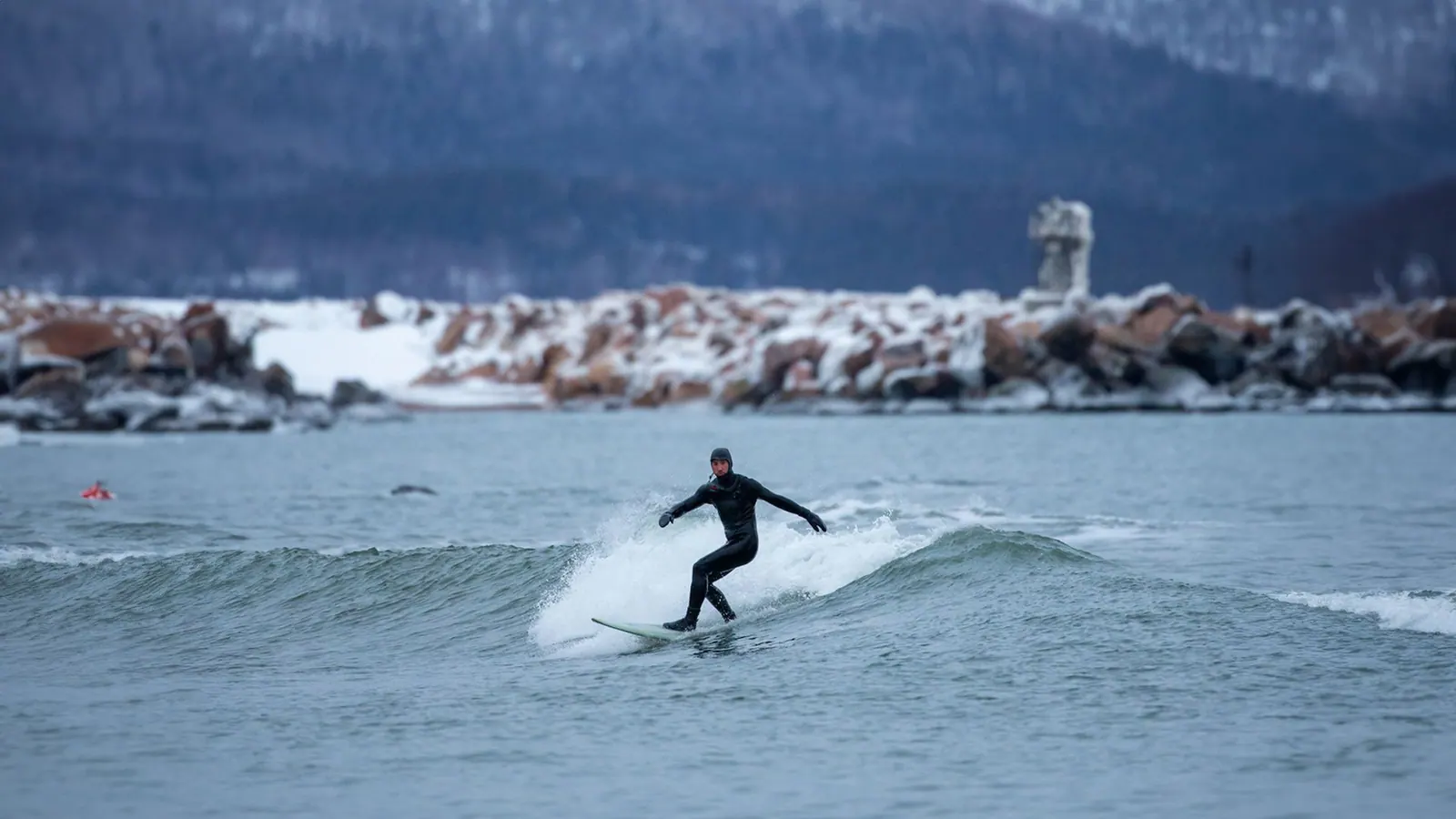 Surfer riding an Atlantic wave off Ingonish