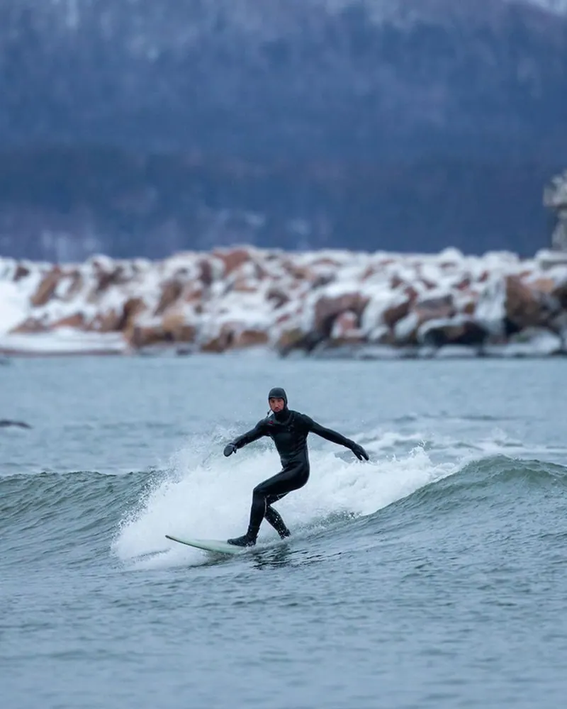Surfer riding an Atlantic wave off Ingonish