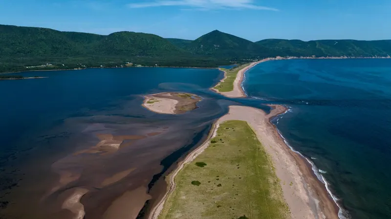 Aerial view of a sandbar and beach between two bays