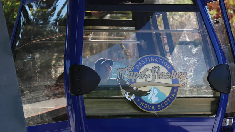 Cape Smokey logo on the window of a blue gondola cabin