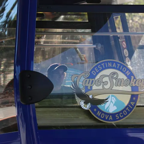 Cape Smokey logo on the window of a blue gondola cabin