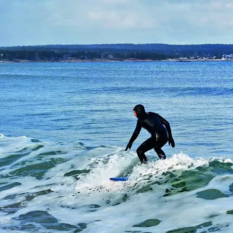 Surfer riding a breaking wave