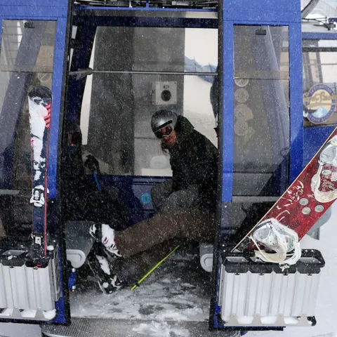 Skier and snowboard racks on a gondola cabin in winter