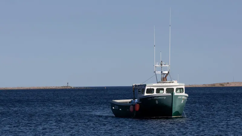 Fishing boat at anchor on calm water