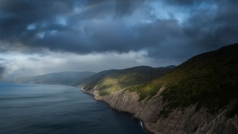 Coastal cliffs and highlands under a stormy sky