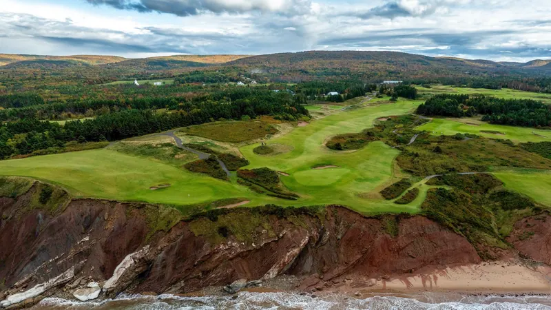 Aerial view of a links course above red sea cliffs