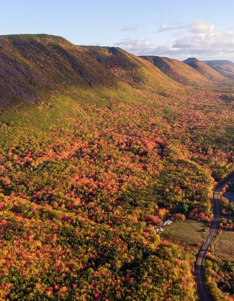 The Cabot Trail winding along the coast through autumn-coloured highlands