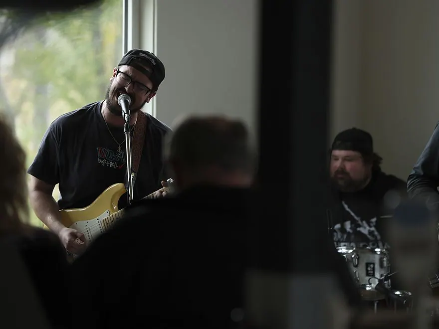 Guitarist and drummer playing a live set to an audience
