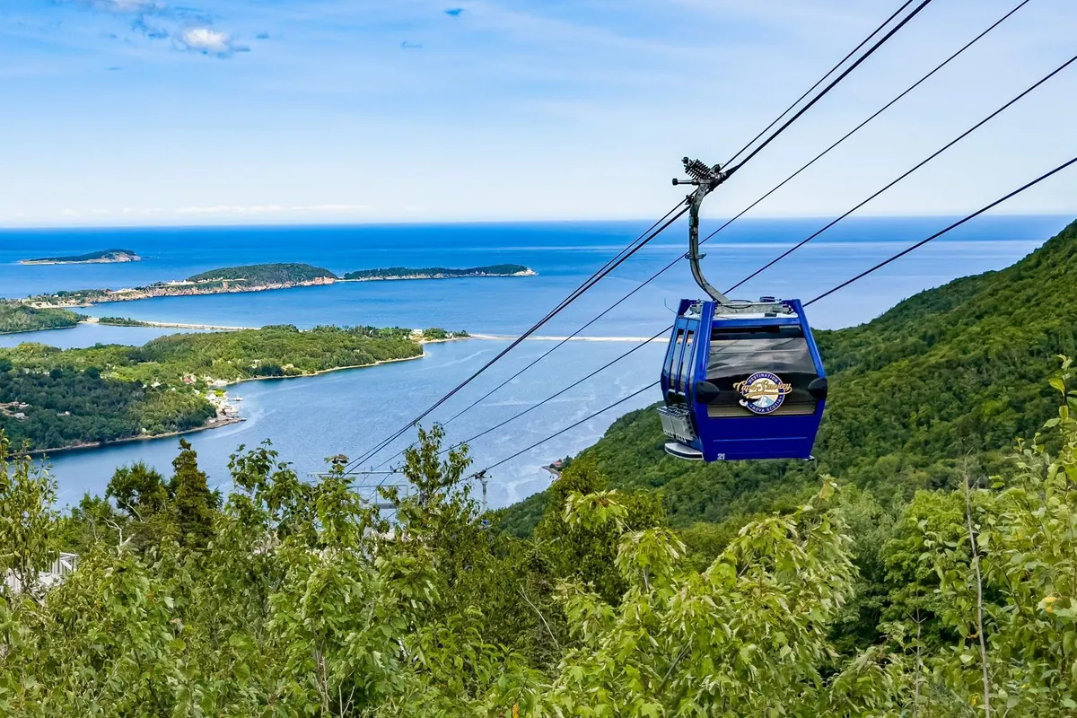 Blue Cape Smokey gondola cabin above the forest, with Ingonish Bay and the Atlantic below