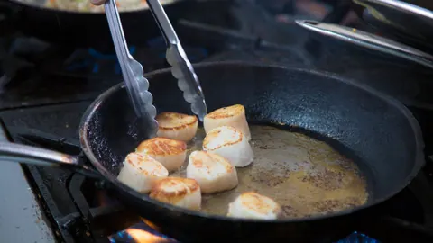 Scallops searing in a pan