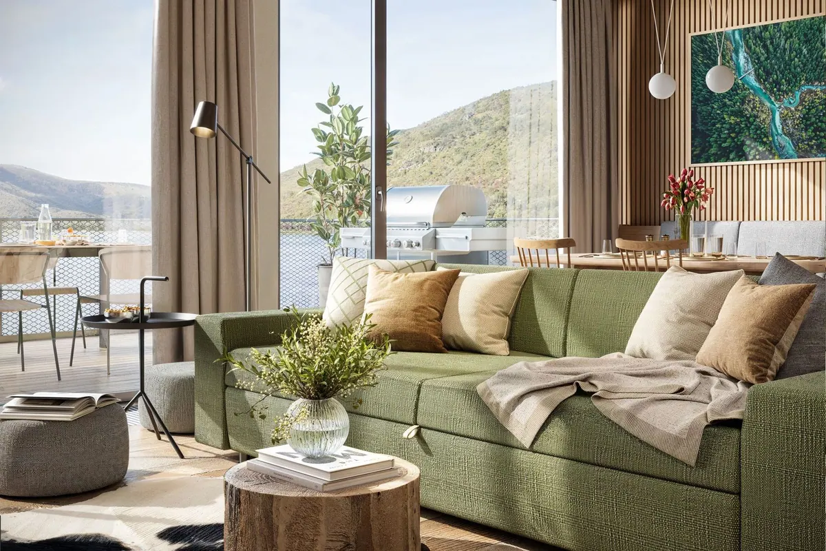 Green sofa in the living room beside timber walls