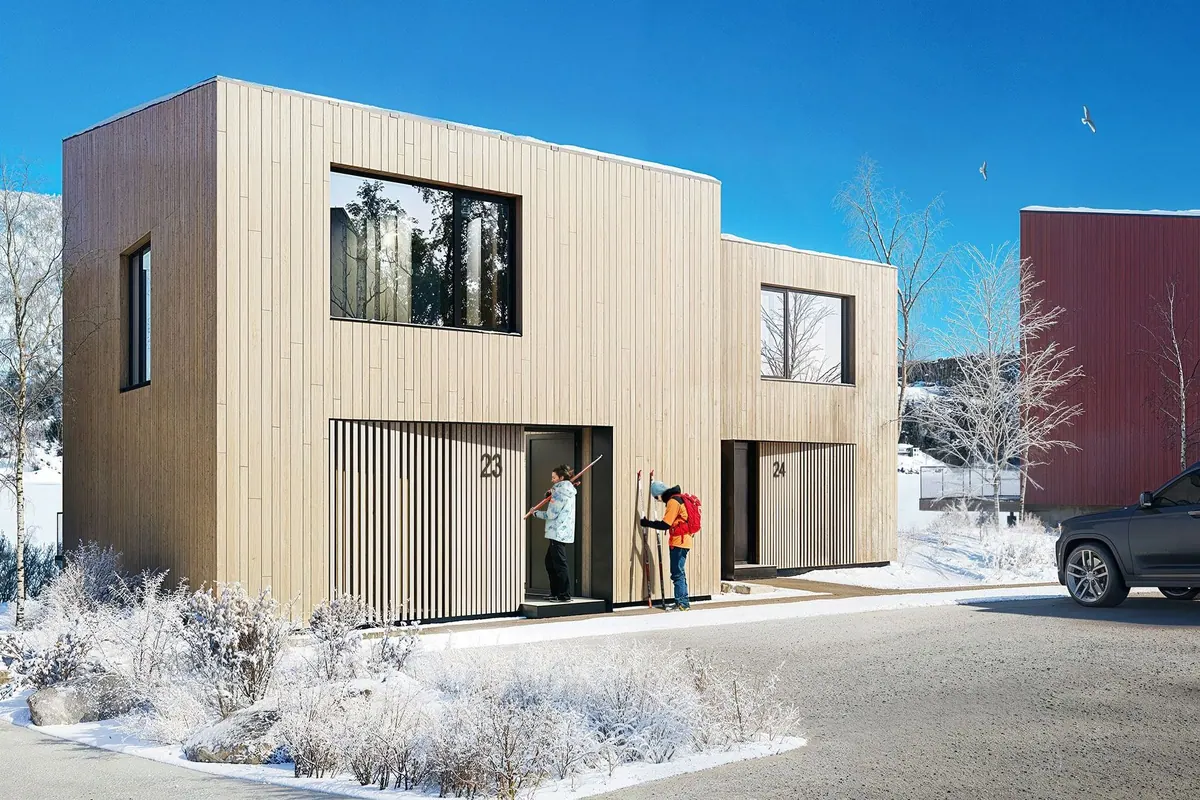 Chalet with timber cladding in a snowy winter landscape