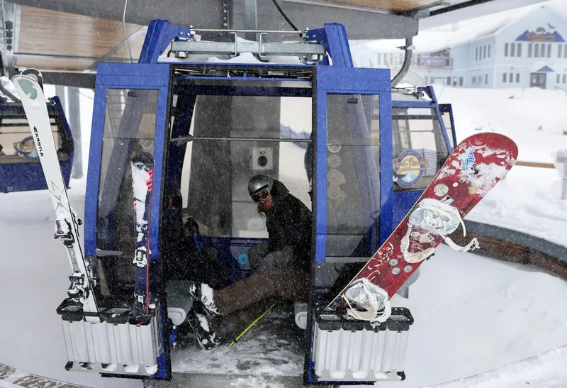 Skis and snowboard racked on a Cape Smokey gondola cabin