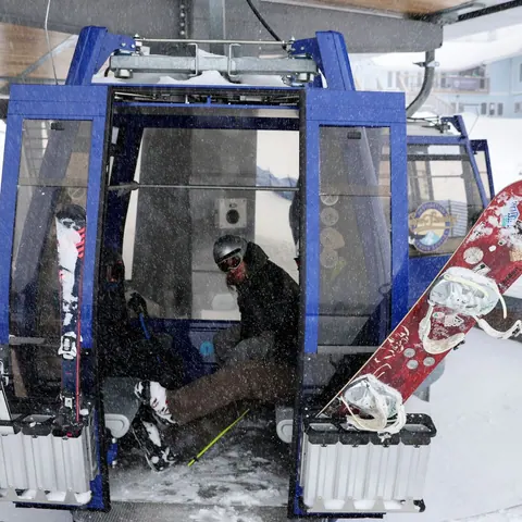 Skis and snowboard racked on a Cape Smokey gondola cabin