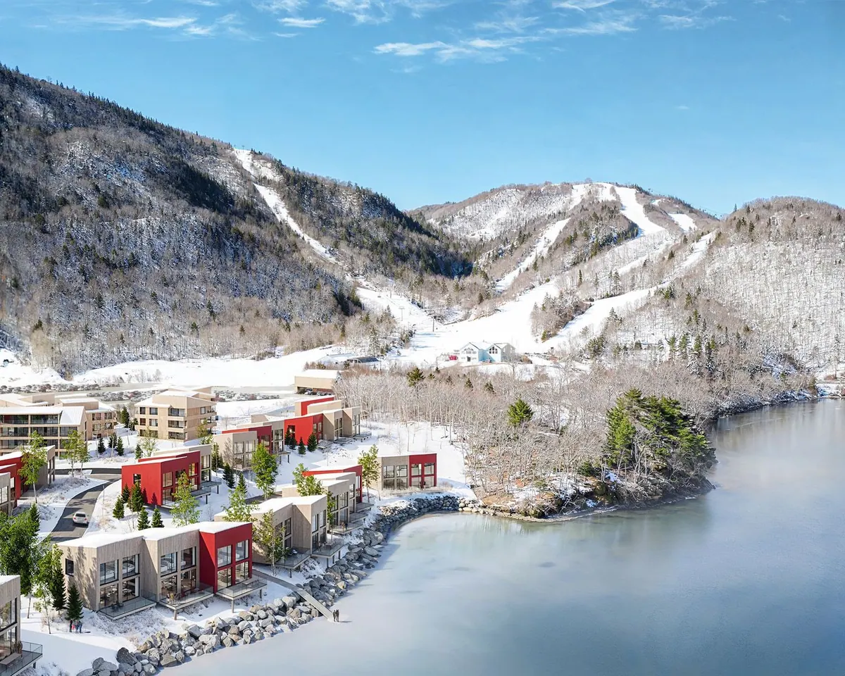 Cormorant Rock chalets under snow by the frozen shore