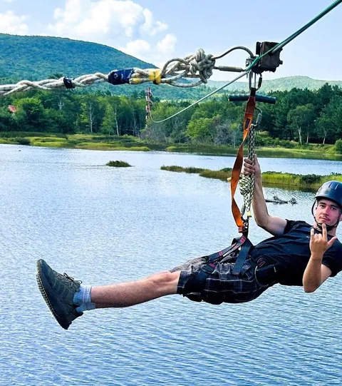 Zipline rider above the treetops of Cape Breton